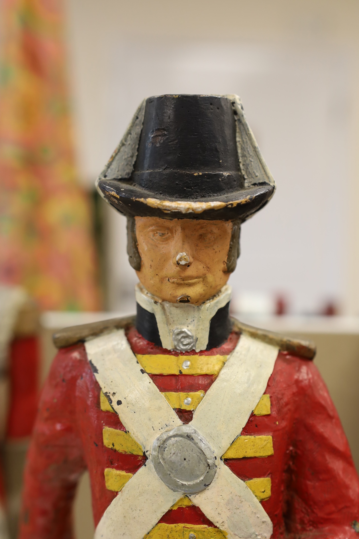 A pair of painted figures of soldiers in military dress, 49cm high. Condition - fair